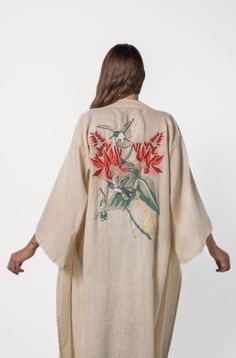 The Hummingbird Kimono from La Troupe is a truly exquisite garment. Made from high-quality cream-colored linen, it features stunning hand embroidery on the back that showcases the skilled craftsmanship of Mayan embroiderers. The vibrant and colorful hummingbird design captures the ancestral magic of these traditional embroidery techniques. Please note that each piece is handmade, making it unique. As a result, there may be slight irregularities or variations in the embroidery, printing, or color Holistic Clothing, Ancestral Magic, Colorful Hummingbird, Kimono Outfits, Hummingbird Design, Embroidery Kimono, Silk Cape, Goddess Gown, Linen Kimono