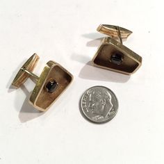 "These are beautifully made 1960s 14k gold cufflinks that recently came out of fine Midcentury Modern estate. They have a brushed Florentine type finish within a gold frame. There is a star sapphire in each cufflink. The cuffs have a very modernist kind of feel to them. The cufflinks are in great condition as you can see in the photos. One of the shanks is at a slight angle. They weight in at 11.8 grams of 14K gold for the two. They are marked \"14K\". The tops measure 7/8\" by 3/4\". The cuffli Modernist Brass Jewelry For Formal Occasions, Modernist 14k Gold Jewelry For Formal Occasions, Formal Rectangular Brass Jewelry, Mid-century Polished Finish Jewelry For Anniversary, Mid-century Yellow Gold Formal Jewelry, Mid-century Polished Formal Jewelry, Vintage Yellow Gold Business Jewelry, Vintage Yellow Gold Jewelry For Business, Yellow Gold Vintage Jewelry For Business