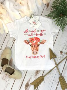 a white tee shirt with a cow wearing flowers on it and the words, my favorite is