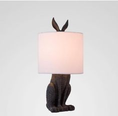 a black cat lamp with a white shade on it's head and ears sticking out