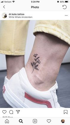 a small flower tattoo on the ankle