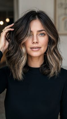 This voluminous brunette balayage highlights a striking contrast between dark roots and blonde ends. The shoulder-length waves add volume and bounce, perfect for a bold and glamorous look. Her black turtleneck and chic interior setting complement the sophisticated vibe. I’m thrilled to offer this stunning and dynamic hairstyle to clients who love making a statement. Roots And Highlights, Medium Length Brown Hair With Balayage, Dark Root Blonde Ends, Blonde Ends Dark Roots, Dark Hair With Blonde Ends, Black Roots Balayage, Brunette Balayage Hair Blonde Dark Roots, Balayage Hair Dark Roots