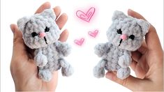 two hands holding small stuffed animals with hearts in the sky behind them, one is gray and the other is pink