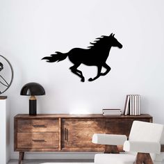 a wall decal with a horse running in the wind on it's side