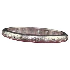 Beautiful Antique Art Deco Platinum Single Cut Diamond Engraved Eternity Band - Size 5 1/2. This beautiful wedding band is crafted in platinum. The ring has deep set single cut diamonds that go around the entire ring. The ring is in fair condition with no structural issues and sits low on the finger. Item #R1655 Metal: Platinum Weight: 2.3 Grams Size: 5 1/2 Diamonds: Approximately .15 cts Color: H - I Clarity: VS2 - SI1 Measurements: Top of the ring measures 2.25 mm wide and band measures 2.25 mm wide. Measurements off the finger: 1.43 mm high Layaway: For your convenience, we will be happy to provide layaway payment options. Please contact us to work out a layaway plan which best suits your needs. All layaway purchases are final sale. All domestic and international shipments are shipped w Luxury Silver Bands With Single Cut Diamonds, Diamond Cut White Gold Bands For Marriage, White Gold Diamond Cut Bands For Marriage, Silver Wedding Bands Hallmarked, Ceremonial Silver Diamond Ring, Formal Silver Platinum Bands, Silver 14k White Gold Wedding Bands, Wedding Bands In 14k White Gold Silver, Luxury Silver Engraved Bands