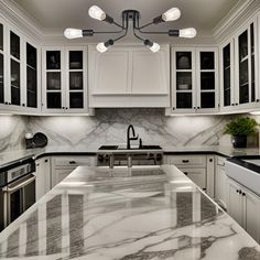 a kitchen with marble counter tops and white cabinets