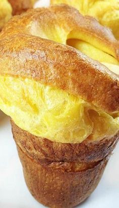 there are two muffins that have been stuffed with egg and bread in them