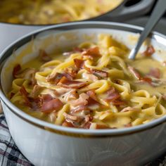 a bowl of pasta with ham and cheese