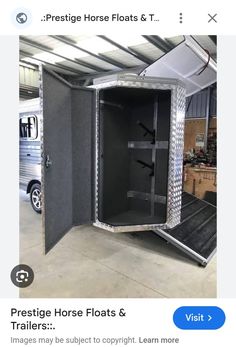 a horse trailer with its doors open and the door opened to show it's interior