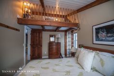 a bed sitting under a wooden beam in a bedroom next to a dresser and window