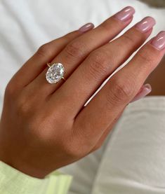 a woman's hand with a diamond ring on it