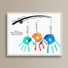 a card with two handprints hanging from a string and the words happy father's day written on it