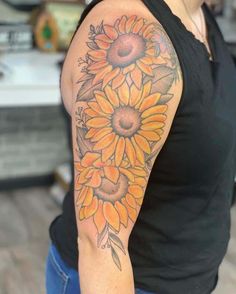 a woman with a sunflower tattoo on her arm