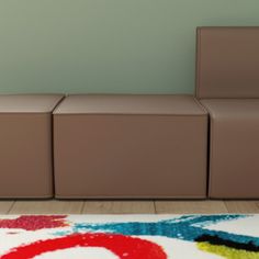 a brown couch sitting on top of a white rug