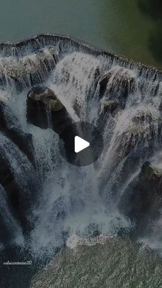 an aerial view of a waterfall in the water