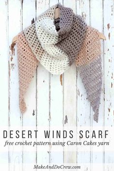 a crocheted scarf hanging on a wooden wall with text overlay that reads desert winds scarf free crochet pattern using canon cakes yarn