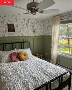 a bedroom with green walls and white bedding has a fan on the wall above it