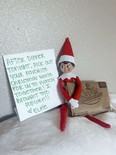 an elf is sitting next to a sign that says after dinner, pick out your favorite chocolate bar