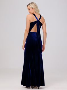 the back of a woman wearing a blue velvet evening gown with one shoulder cut out