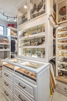 a large closet filled with lots of shoes and other items in it's shelves