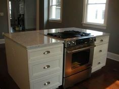 a kitchen with an island and stove in it