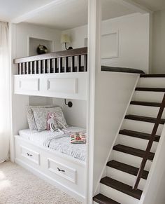 there is a bunk bed in the room with stairs to the top and bottom floor