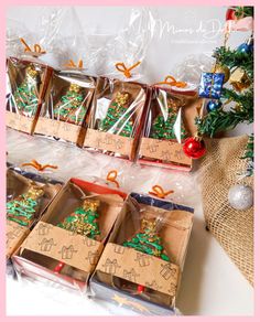 there are many boxes that have christmas cookies in them on the table next to each other