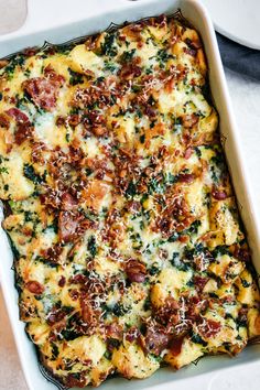 a casserole dish with cheese, bacon and spinach