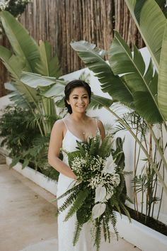 a woman in a white dress holding a bouquet