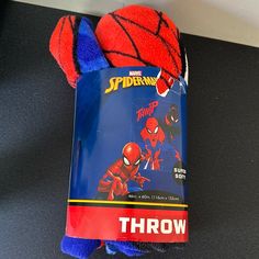 a spider - man towel and toy on a table