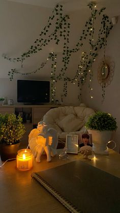 a living room filled with lots of furniture and plants on top of a wooden table