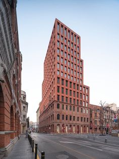 two tall brick buildings next to each other on a city street