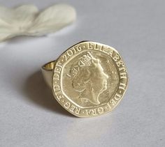 Signet ring women, gold coin ring, signet ring, pinky coin ring, coin ring, vintage ring, cocktail ring, graduation gift, gold pinky ring This coin ring is made of an old British 20p coin which was attached to a wide band to create a lovely signet ring for women. The pinky coin ring is available both in 14k gold plating and sterling silver The gold signet ring was designed in a vintage style and is just a great gift for women. Dimensions: The coin diameter is 2 cm (a bit over 0.75 inches) The co Vintage Coin Signet Ring As Gift, Vintage Coin Signet Ring For Gift, Vintage Coin Shaped Signet Ring Gift, Gold Coin-shaped Engraved Signet Ring, Gold Engraved Coin Signet Ring, 14k Gold Coin Shaped Anniversary Rings, Elegant Engraved Coin Rings, Gold Coin-shaped Ring For Anniversary, Gold Coin-shaped Anniversary Ring