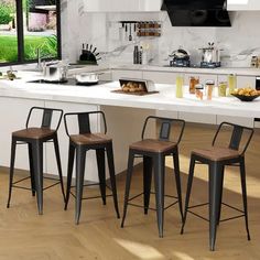 three stools sit in front of a kitchen island