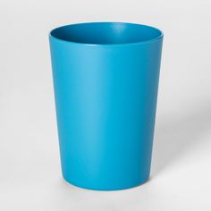 a blue cup sitting on top of a white table