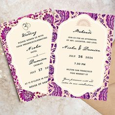 two purple and white wedding cards on top of an envelope