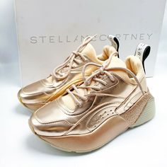 Up for sale is a pair of new in box and authentic STELLA MCCARTNEY Eclypse Lace Up Sneakers. MSRP $685. Size 35. Please note the shoes are past season stock so they may show minor shelf wear / marks. The box may also have wear and tear, however rest assured the shoes are new and unused. We kindly ask buyers to please only purchase if you are certain about the fit & size. We strongly suggest buyers to please try the shoes at retail stores before purchasing on eBay so that you are 100% sure about Designer Platform Sneakers With Rubber Sole, Designer Low-top Platform Sneakers, Gold Wedge Sneakers With Round Toe, Gold Platform Sneakers With Round Toe, Luxury Platform Sneakers With Boost Midsole, Luxury Round Toe Platform Sneakers, Copper Rose Gold, Copper Rose, Metallic Copper