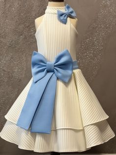 Gorgeous neoprene white cocktail, opening number dress with baby blue accents. Zipper back. Color: white, baby blue. Fabric: neoprene, striped neoprene. White Party Dress With Satin Bow, Fitted White Dress With Bow Tie, Elegant White Dress With Bow Tie, White Fitted Dress With Bow Tie, Fitted Blue Dress For Baptism, Blue Wedding Dress With Satin Bow, Formal White Dresses With Satin Bow, White Formal Dress With Satin Bow, White Dress With Satin Bow For Baptism