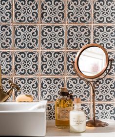 an image of a bathroom with tile on the wall and sink in front of it