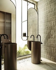 a bathroom with two sinks and mirrors in front of a large window next to a plant