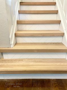 some wooden steps leading up to a white wall