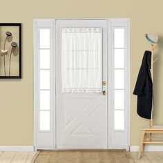 a white front door with curtains and a coat rack