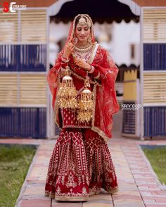 a woman in a red and gold bridal outfit