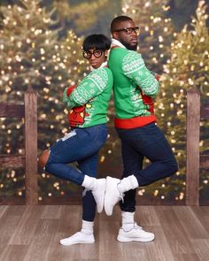 two people are dancing in front of a christmas tree