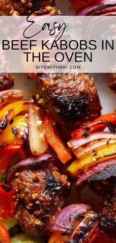 beef kabobs in the oven with onions, peppers and carrots on top