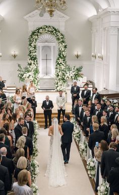 the bride and groom are walking down the aisle