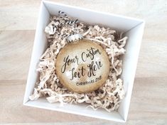 a personalized ornament in a gift box for someone's christmas tree