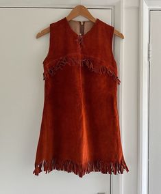 Vintage 1970s Suede Mini Dress - AS SEEN. Really cute. Does up with a zip at the back. Fringe, tassels detail. And little tie at the bust.  ~ some marking as shown. and a tear at the bottom fringe section  Bust: 34"  Waist: 33" Hips: 34" Length: 30"  Looks to be in very good condition for its age. Bear in mind though it is vintage and preloved so it won't be perfect and maybe imperfections I've missed when looking it over  When you unpack your order, hang it up and let it relax to let the crease Vintage Fitted Dress With Fringe, Fitted Vintage Dresses With Fringe, Sleeveless Brown Fringe Dress, Sleeveless Brown Dress With Fringe, Brown Sleeveless Fringe Dress, Vintage Fringe Dress, Suede Mini Dress, Fringe Mini Dress, Suede Dress