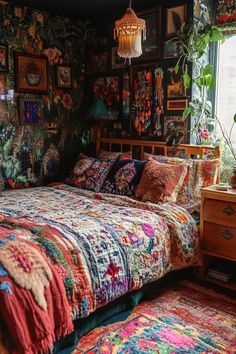 a bed in a bedroom next to a window with pictures on the wall behind it