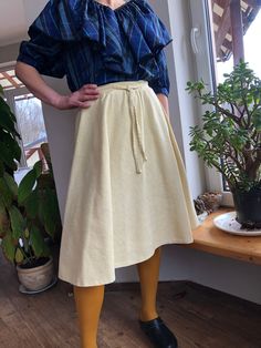 "Vintage half circle skirt. 70s yellow midi skirt. Half circle skirt with front tie and side zipper. Lined. Marked as size 38 65% polyester 35% cotton Lining 100% acetate To fit size S/M Waist 27\" 69cm Length 25\" 63cm Some defects on lining, see on last photo" Spring Cotton Wrap Skirt With Gathered Detail, Knee-length Cotton Wrap Skirt For Spring, Spring Cotton Gathered Wrap Skirt, Cotton Knee-length Wrap Skirt For Spring, Beige Cotton Wrap Skirt For Spring, Yellow A-line Bottoms For Spring, Half Circle Skirt, Yellow Midi Skirt, White Long Sleeve Blouse